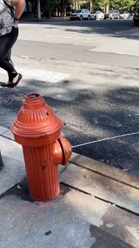 Leaking Red Fire Hydrant on Urban City Sidewalk