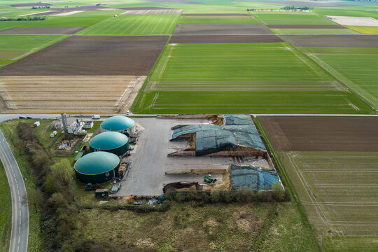 Aerial view of a biogas plant nestled amidst a patchwork of brown and green fields, a symphony of rural industry and agriculture, Gross-Umstadt, Hessen, Germany.