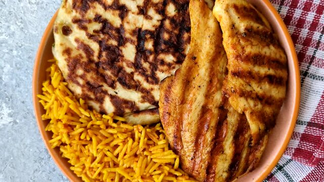 Dajaj Mashwi, an Arabic dish with rice and chicken, salt, and spices. Dajaj Mashwi as a food background for your design