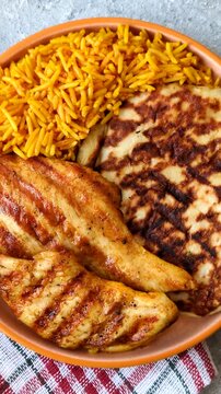 Dajaj Mashwi, an Arabic dish with rice and chicken, salt, and spices. Dajaj Mashwi as a food background for your design