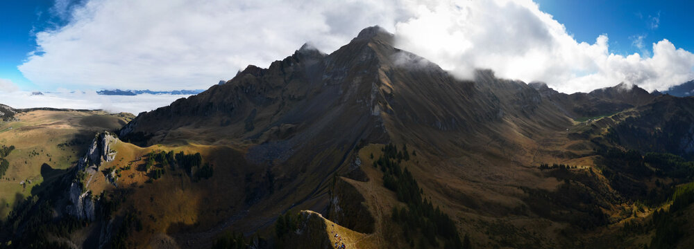 Aerial view of the rugged Pic de Jallouvre mountain range, where peaks meet the sky and shadows dance across the slopes, Glieres-Val-de-Borne, Auvergne-Rhone-Alpes, France.