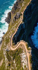 Obraz premium Dramatic Coastal Cliffside Path Winding Towards Ocean Horizon