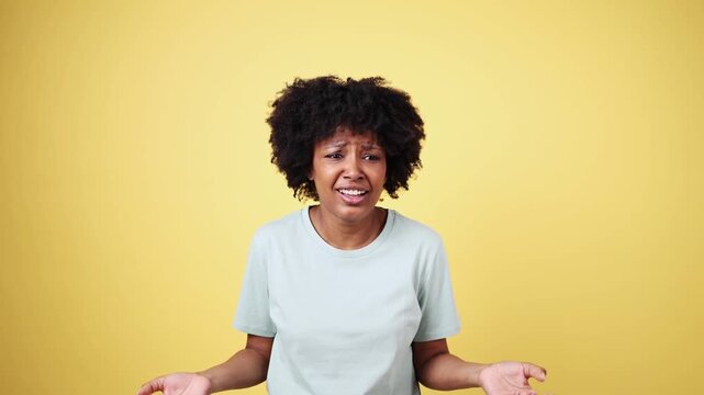 Woman expressing confusion and frustration on yellow background