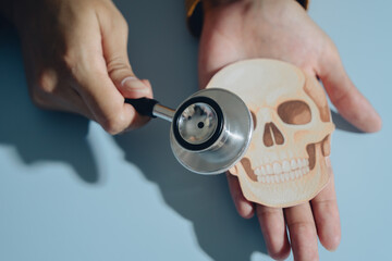 Fototapeta premium Stethoscope skull hand medical health anatomy doctor human examination healthcare close up person palm bone diagnostic instrument skeleton detail clinic professional care body medicine tool white
