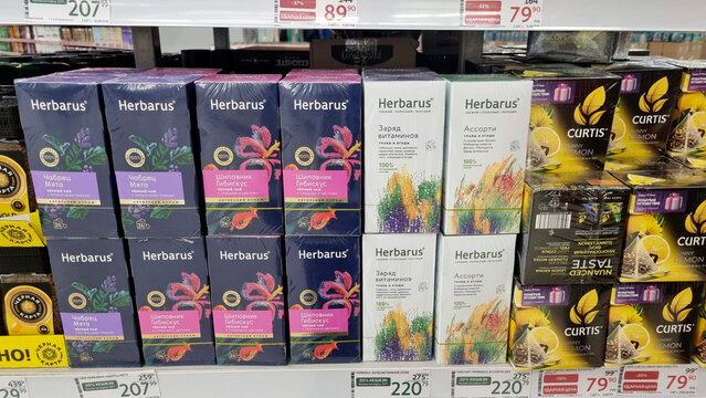 Herbal tea boxes on supermarket shelf with colorful packaging