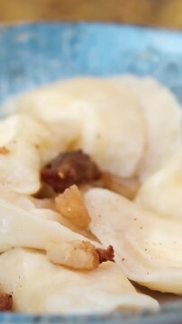 Dumplings blue plate Dumplings gyoza mandu on a blue plate with wooden chopsticks. High quality 4k footage