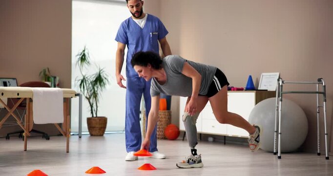 Balance, exercise or prosthetic with patient and physiotherapist in office for recovery or rehabilitation. Healthcare, medical or mobility with amputee woman and man in physical therapy clinic