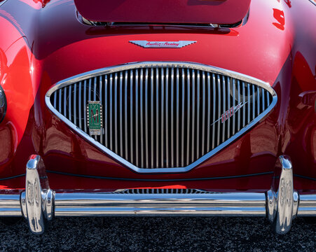 Georgetown, TX - 28 February 2026: Chrome radiator grille of classic red Austin Healey 100M sports car