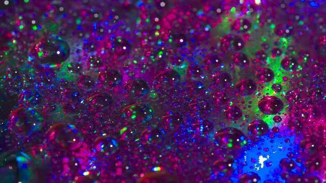 Sparkling Crystal Material in Laser. Drops of a chemical saturated solution applied to a mirror plate slowly move in multiple beams of laser radiation