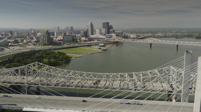 An aerial flyover of the Ohio river and bridges approaching Louisville, KY