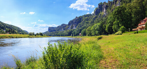 Naklejka premium Beautiful landscape, panorama, banner - View of the Elbu River and the Elbe Sandstone Mountains near the village of Rathen, in Saxony, Germany