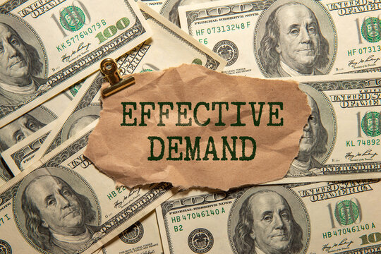 Effective Demand text written on paper with magnifying glass.