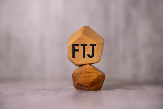 FTJ. text on wood cubes. text in black letters on wood blocks