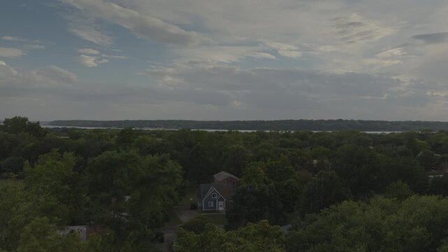 A rising aerial shot of a small town and trees, Nauvoo, IL