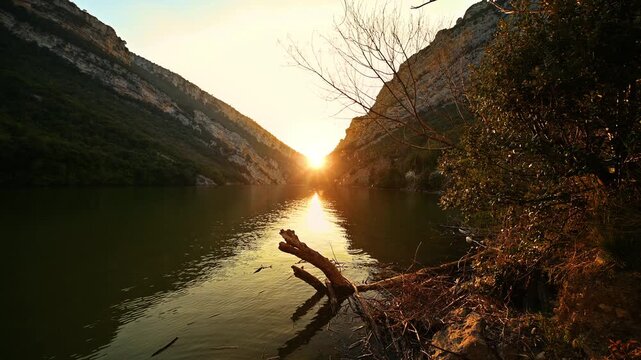 Cinematic Sunset at Sobron Canyon in Burgos province, Spain, with Ebro River Flowing Between Mountains and Sunlight Filtering Through Tree Branches. High quality 4k footage
