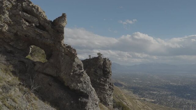 An aerial shot of a strange rock formation and arch above Utah Valley, Uinta National Forest, UT