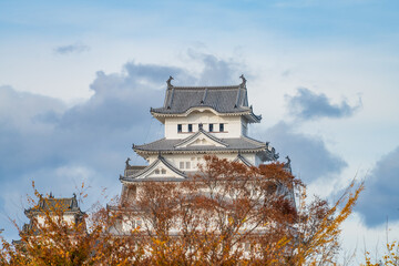 Himeji castle behind the autumn trees. Himeji city. Japan