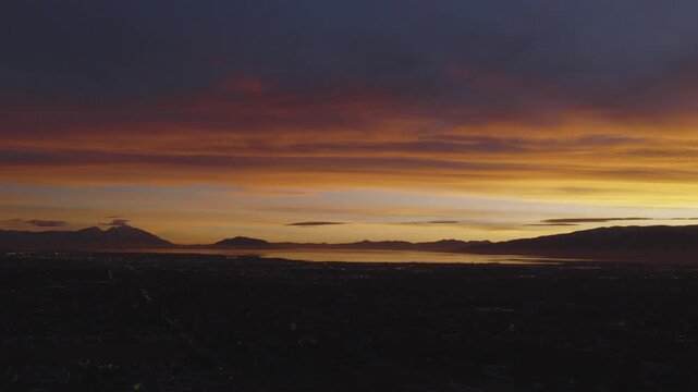 An aerial shot of a dramatic sunset over Utah Lake and Valley, Pleasant Grove, UT