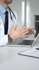 Doctor in white coat showing test results to patient on tablet during consultation. Medicine, healthcare and science concept © volha_r
