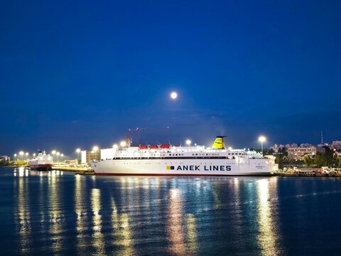 Photo of the passenger ferry Asterion II docked at the E3 gate of Piraeus Port in the quiet pre-dawn blue hour. 