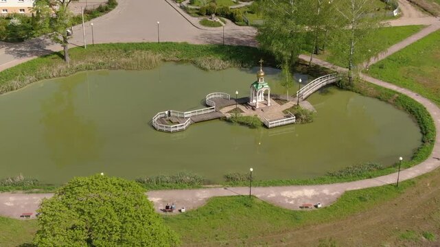 Drone circling above pond in Klin park