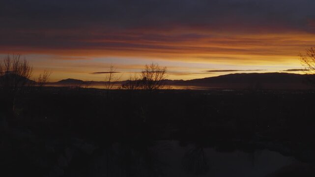 An aerial shot of a dramatic sunset over Utah Lake and Valley, Pleasant Grove, UT
