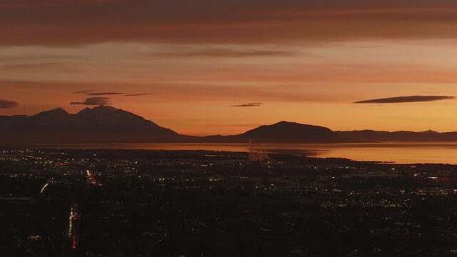 An aerial shot of a dramatic sunset over Utah Lake and Valley, Pleasant Grove, UT