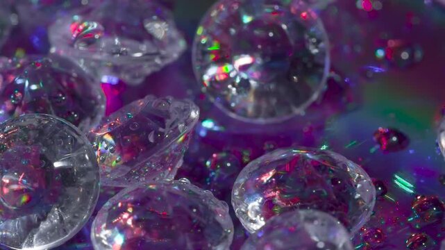 Polishing of Diamond Blank Facets. Small crystals with a classic cut on a mirror surface slowly move in front of the camera, shimmering in the laser beams