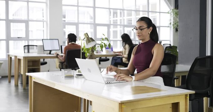 Professional woman finishing typing shuffling docs sipping mug checking phone for updates at office