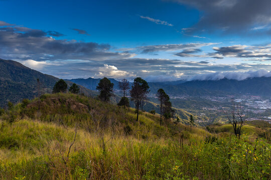 Cityscape View from Waraira Repano Mountains at Dusk. Panoramic view of the urban horizon at sunset, captured from the high-altitude trekking trails of Guatire, Miranda, Venezuela. South America