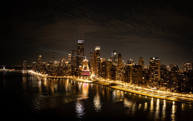 Fototapeta premium Aerial View of Chicago Skyline at Night March 21 2026 Illuminated Downtown Cityscape