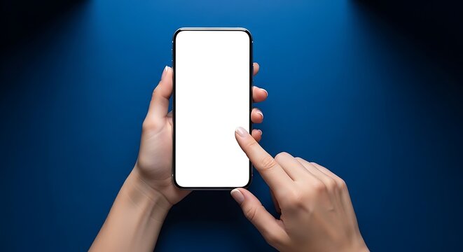 Top-down view of human hands holding and interacting with a modern smartphone featuring a blank white screen, set against a deep blue textured background with spotlight illumination, highlig