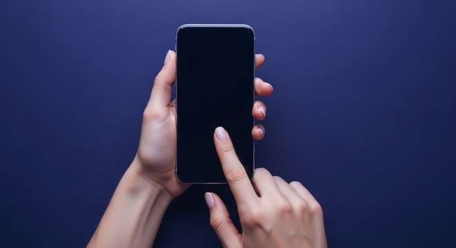 Elegant female hands delicately hold and interact with a sleek, modern smartphone displaying a dark, blank screen against a deep blue, flat lay background, emphasizing digital connection and