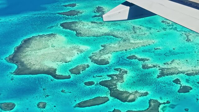 Aerial view of coral reefs and blue sea from airplane near Sharm El Sheikh