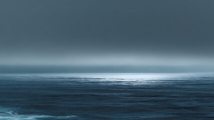 Fototapeta premium A calm ocean with a cloudy sky in the background