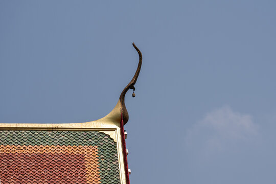 Minimalist View of Thai Temple Roof Finial and Colorful Tiles.