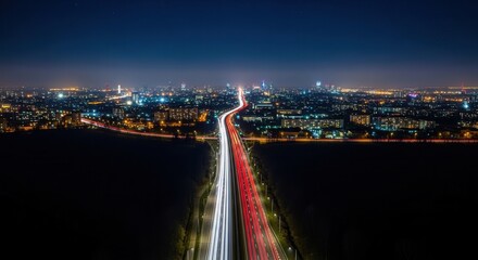 Fototapeta premium Illuminated Cityscape With Streaking Light Trails On Highway At Night