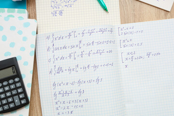 Fototapeta premium Copybooks with math formulas, notebooks and calculator on wooden table, closeup