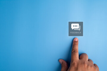 Finger pressing feedback icon on virtual screen, representing customer experience, online review, user satisfaction, rating system, digital communication and service quality evaluation