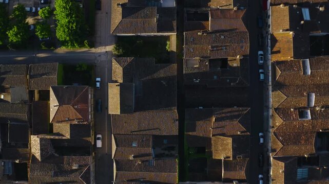 Geometric layout of streets and tiled roofs in the bastide of Monpazier, Dordogne. Birds-eye view from a vertical drone shot.