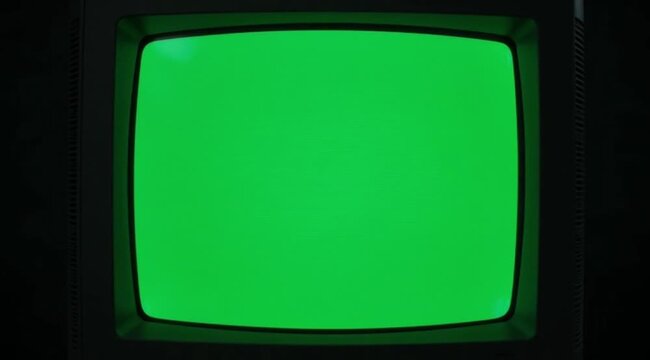 Vintage cathode ray tube television displaying a bright green screen for easy keying.