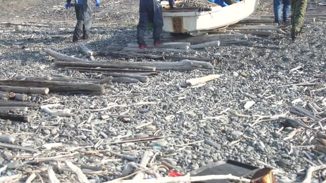 船を陸に上げる漁師