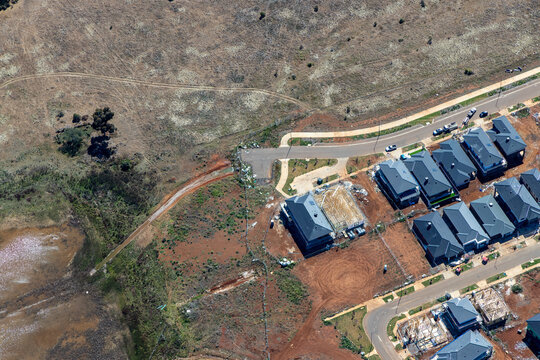Toolern Vale Melbourne Victoria aerial view new housing estate meeting undeveloped rural land
