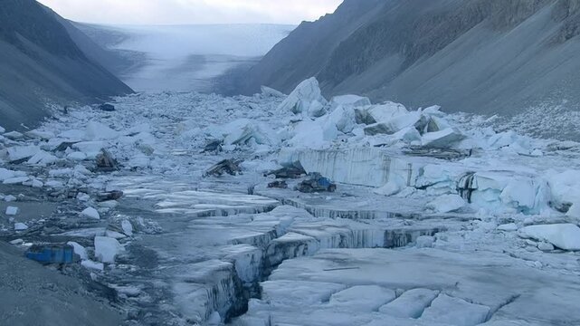 Aerial View of Glacier Collapse &ndash; Massive Ice Chunks Scattered Across Moraine Valley After Calving Event