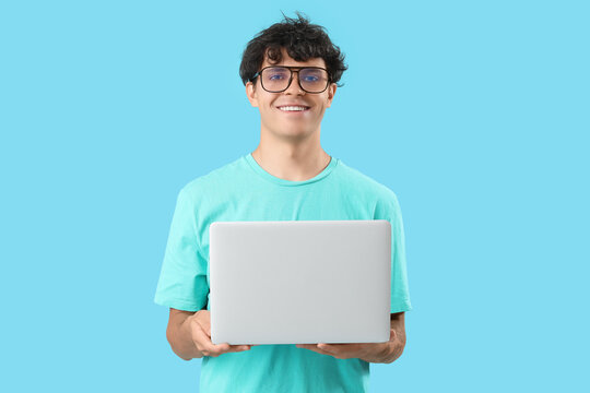 Male programmer with laptop on blue background