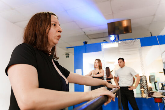 Woman exercising at barre in dance school studio