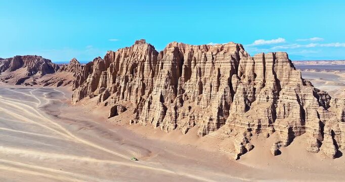 Aerial view of rugged jagged rock formations and a vast desert expanse in the remote wilderness of Xinjiang, China.