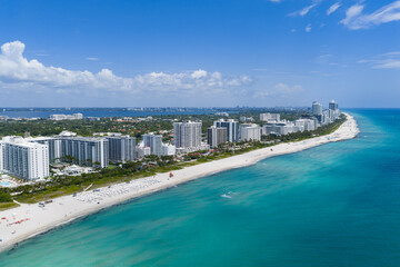 Obraz premium Miami beach with turquoise waters. Aerial view of sandy coastline and waves. Tropical Miami Beach scene with sandy beach.