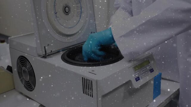 Lab tech gloved hands using panel, lifting lid, seating rotor, preparing centrifuge for analysis