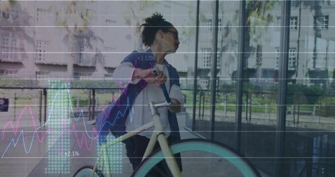 Man pedaling beside glass facade, lifting wheel and bringing bike in amid business charts rising